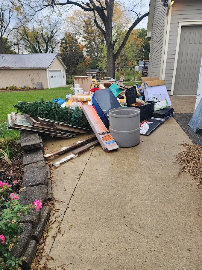 Dumpster being loaded with debris for Roofing Dumpster Rental in Spring Hill